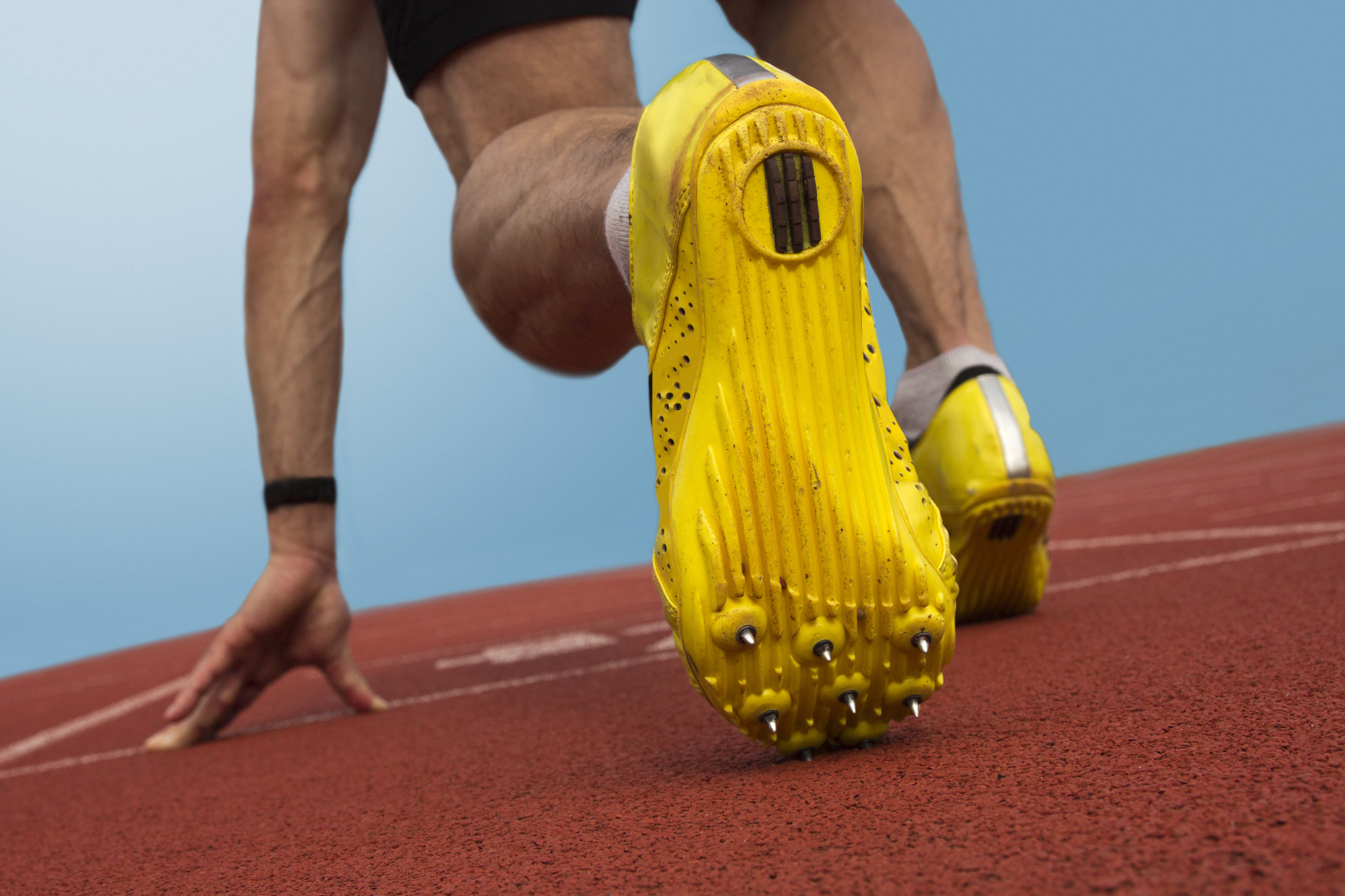 Person on a start line bent down preparing to sprint