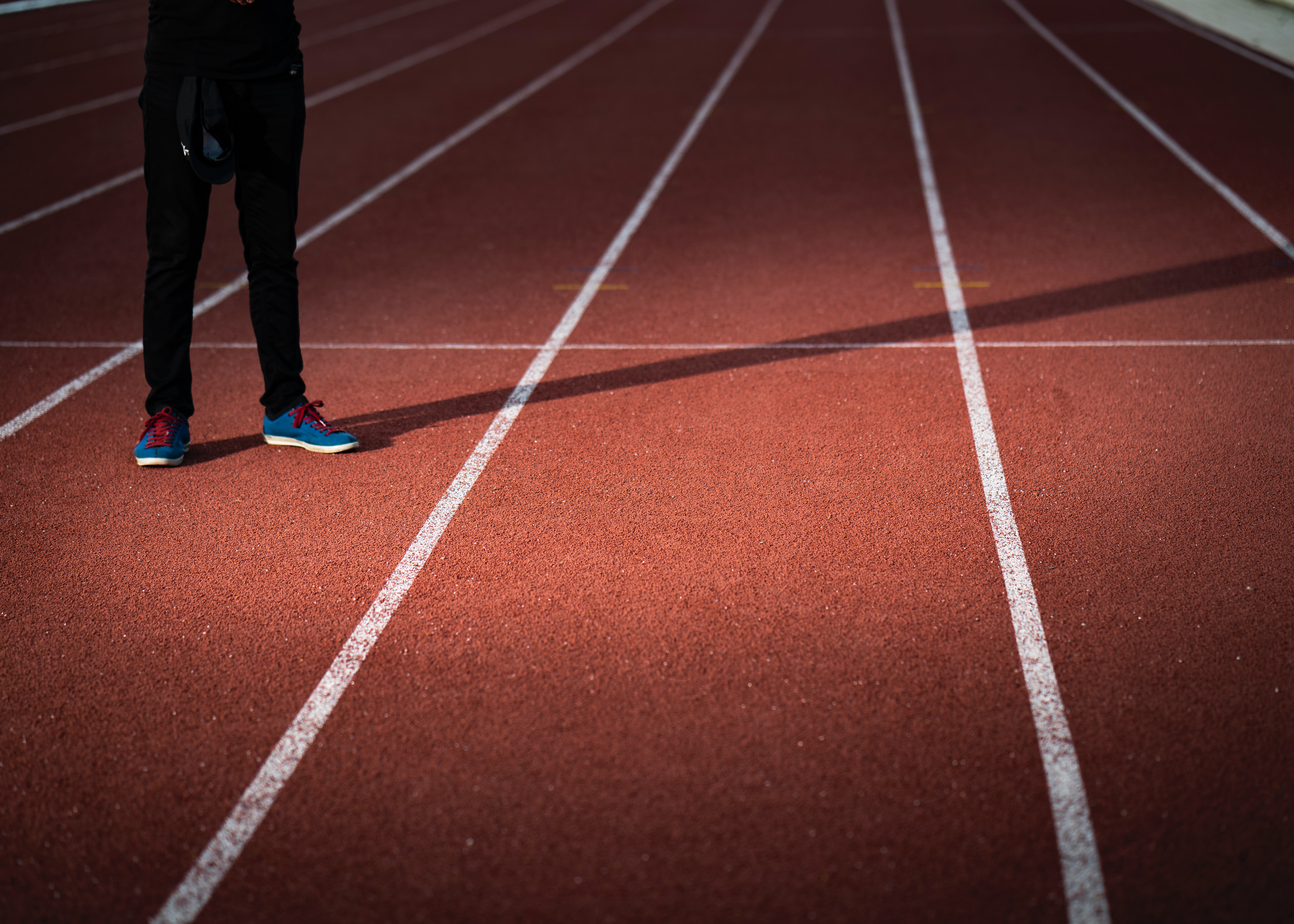 Person standing on a running track