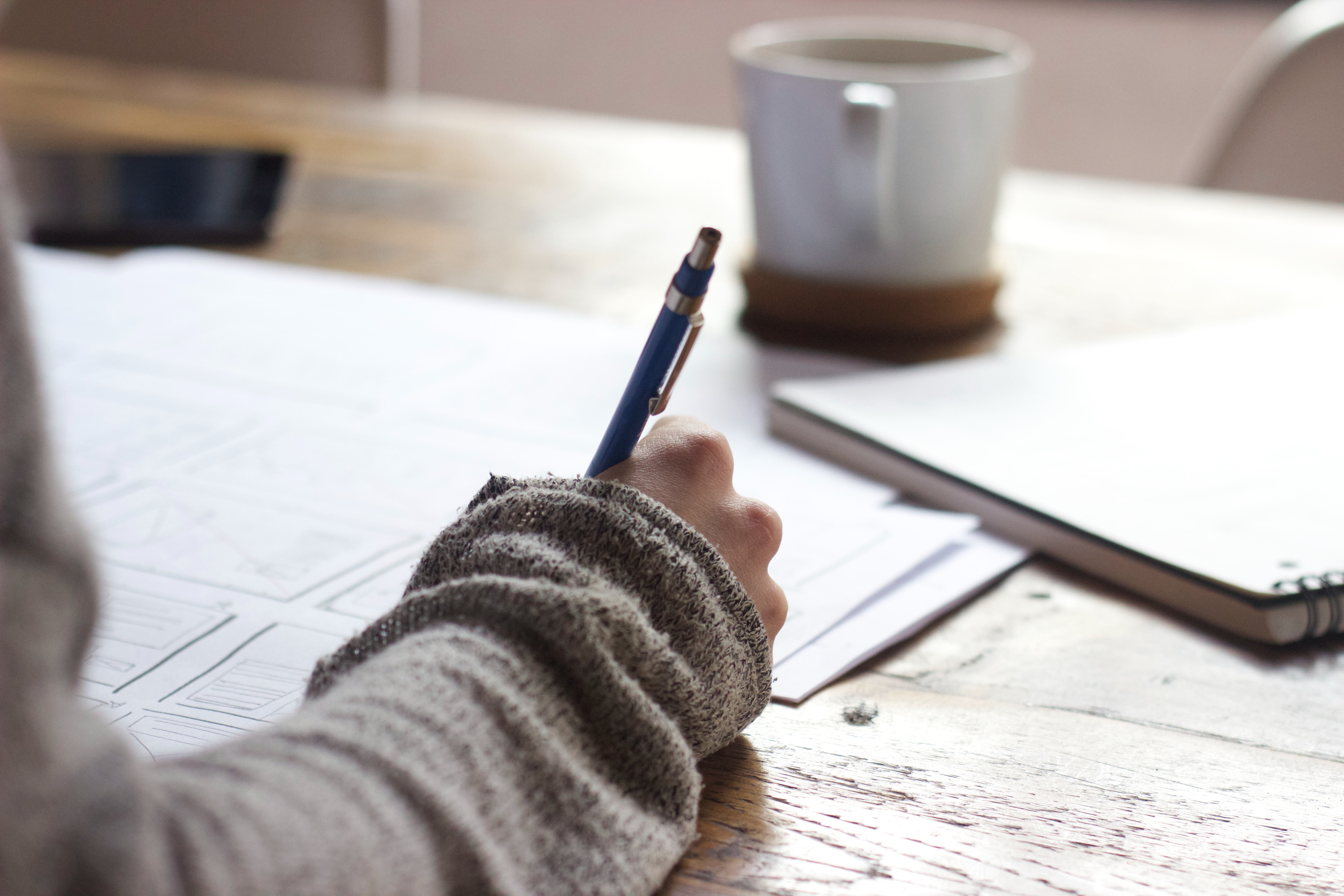 Person writing on a notepad