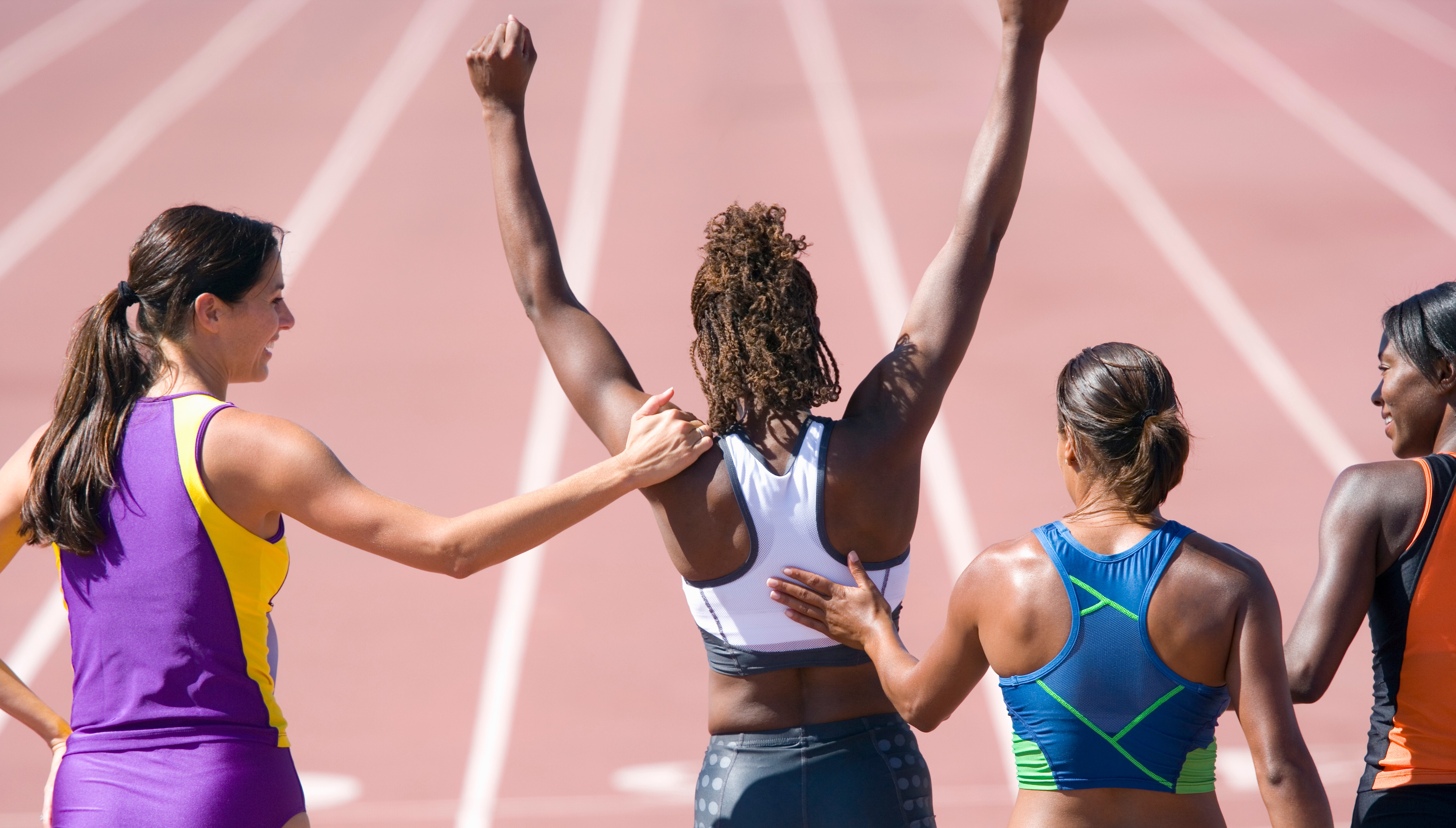 Athletes celebrating on a track