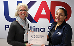 Two people holding an award