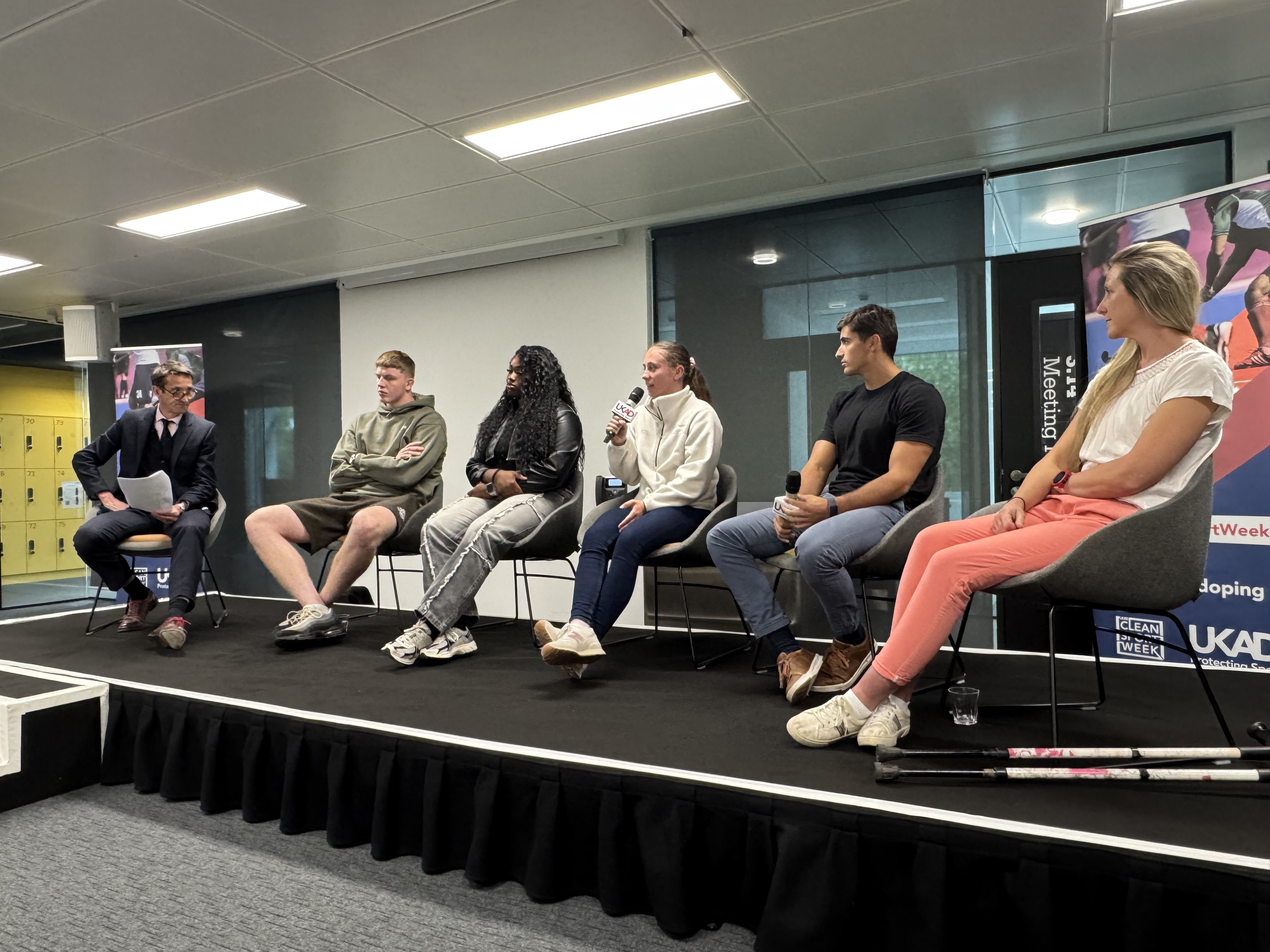 Athlete panel sitting in a line on stage