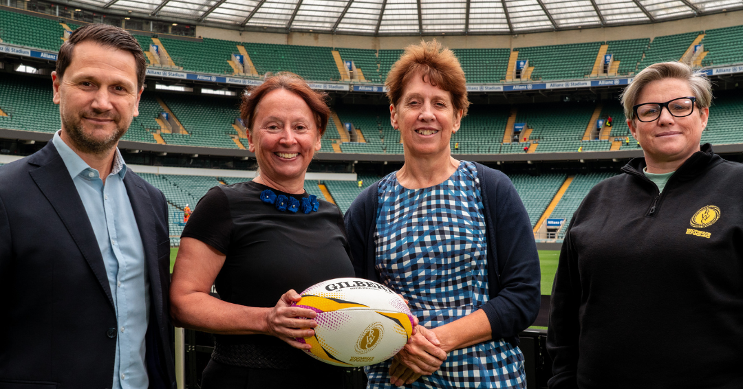 The image shows a photo of four people pitch side at Allianz Twickenham stadium. Pictured from left to right is Mike Earl, Director of Anti-Doping and Game Equipment at World Rugby, Jane Rumble, UKAD Chief Executive, Professor Kim Wolff, Director of King’s Forensics and Head of the Drug Control Centre, and Aimee Bywater-Lutman, Head of Women’s Rugby World Cup Business Operations 